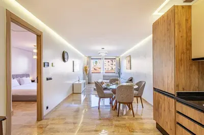 a dining room with a table and a bedroom at New 1BR appt in gueliz in Marrakech