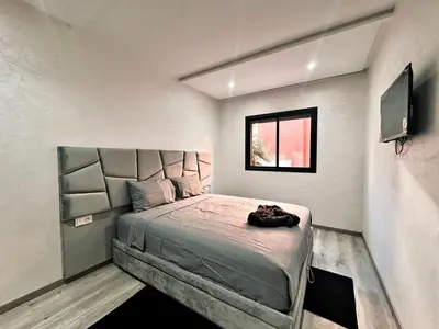 a bedroom with a large bed in a room at Appartement De Luxe Avec Piscine a Marrakech in Marrakech