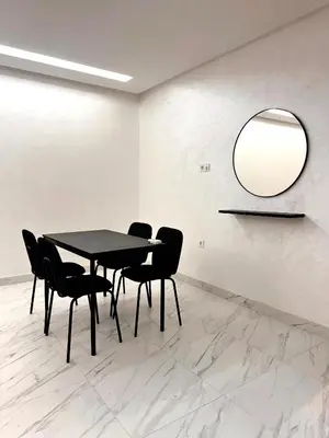 a black table and chairs in a room with a mirror at Appartement De Luxe Avec Piscine a Marrakech in Marrakech