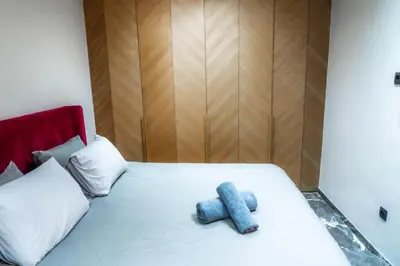 a bed with a blue stuffed animal on it at Nuit d'Amazay in Marrakech