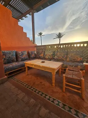a living room with a couch and a table at Marrakech Palmeraie 2 appt 2ch, résidence avec piscine in Marrakech