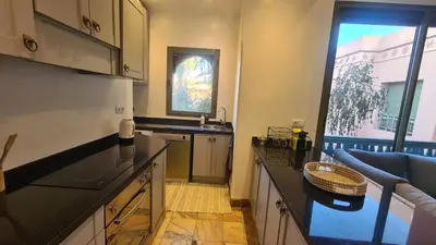 a kitchen with a sink and a counter top at Marrakech Palmeraie 2 appt 2ch, résidence avec piscine in Marrakech