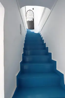 a stairway with blue stairs in a building at riad la girafe blanche de marrakech in Marrakech