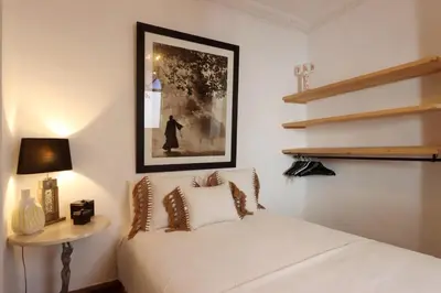 a bedroom with a bed and a picture on the wall at Riad L'Hana, 3 ch, exclu medina in Marrakech
