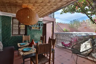 a dining room with a table and chairs on a patio at Riad L'Hana, 3 ch, exclu medina in Marrakech