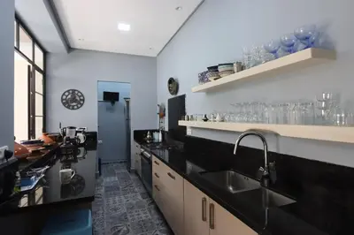 a kitchen with black counters and a sink at Riad Lytes breakfast pool comfort private in Marrakech