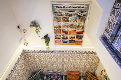 a staircase with a tile floor and a poster on the wall at Smile Hostel in Marrakech