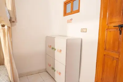a kitchen with a white refrigerator in a room at Smile Hostel in Marrakech
