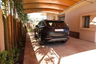 a car parked in a garage next to a building at Mi Casita Luxury Villa marrakech in Marrakech