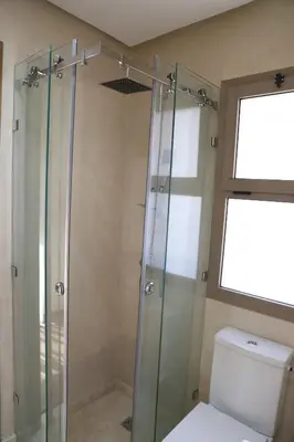a bathroom with a glass shower with a toilet at Mi Casita Luxury Villa marrakech in Marrakech