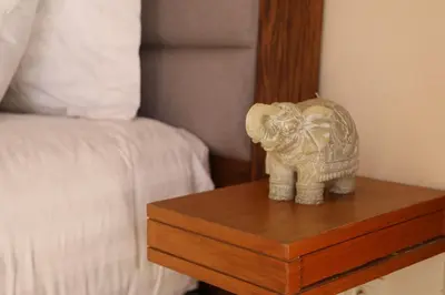 a statue of an elephant on a table next to a bed at Mi Casita Luxury Villa marrakech in Marrakech