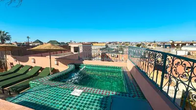 a swimming pool on the balcony of a building at Riad Abi in Marrakech