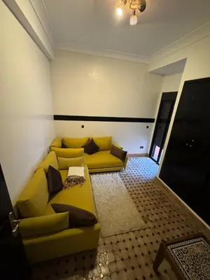 a living room with a yellow couch in a room at Family apartement at Premium village in Marrakech