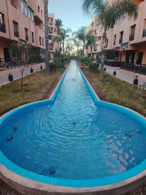 a swimming pool in the middle of a street at Family apartement at Premium village in Marrakech