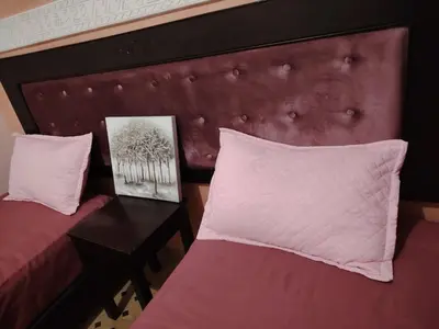 a bedroom with a red headboard and a table with a bed at Élégance Apartment with 5 swimming pool for family in Marrakech