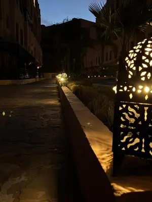 a row of lights on a street at night at Élégance Apartment with 5 swimming pool for family in Marrakech