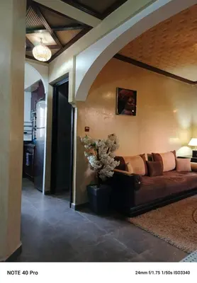 a living room with a brown couch in a room at La nuit est bonne in Marrakech