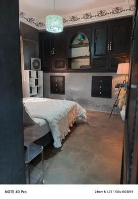 a bedroom with a bed and a mirror and a tripod at La nuit est bonne in Marrakech