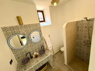 a bathroom with a sink and a mirror and a shower at Riad Nabil with Concierge and FREE Breakfast in Marrakech