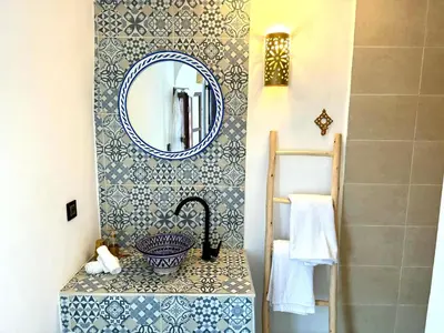 a bathroom with a sink and a mirror at Riad Nabil with Concierge and FREE Breakfast in Marrakech