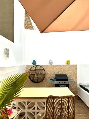 a patio with a table and a grill at Riad Nabil with Concierge and FREE Breakfast in Marrakech