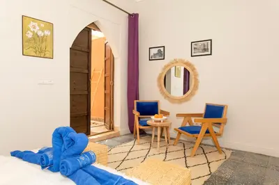 a room with a bed and chairs and a table at the old house in Marrakech