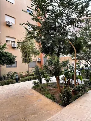 a tree in front of a building at Stylish Appart near the centre in Marrakech
