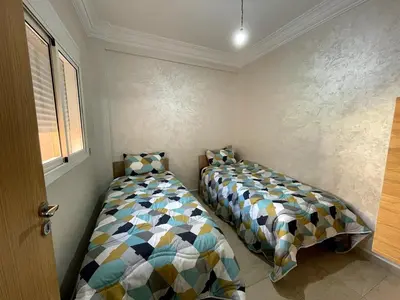 a bedroom with two beds and a window at Stylish Appart near the centre in Marrakech