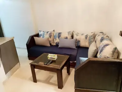 a living room with a couch and a coffee table at Studio Au Centre Ville Marrakech in Marrakech