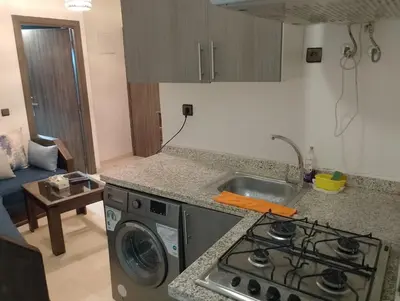 a kitchen with a stove top oven next to a sink at Studio Au Centre Ville Marrakech in Marrakech