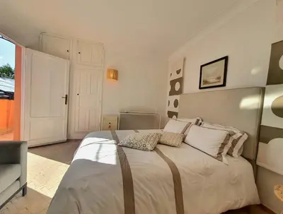 a bedroom with a large white bed with pillows at Family villa pool sauna and hammam in Marrakech