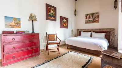 a bedroom with a red dresser and a bed at Dar Salam Marrakech in Marrakech