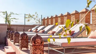 a row of beds sitting on top of a roof at Dar Salam Marrakech in Marrakech