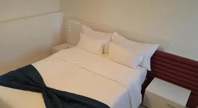 a bed with white sheets and pillows in a room at Marrakxi in Marrakech