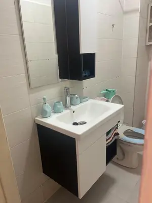 a bathroom with a white sink and a toilet at Au cœur de la ville ocre in Marrakech