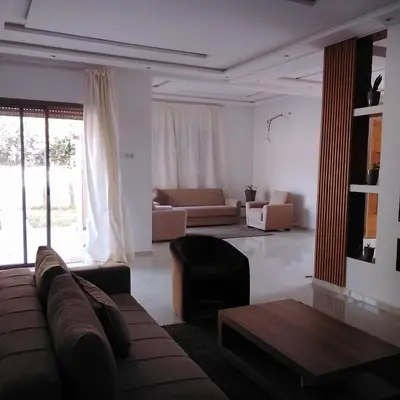 a living room with a couch and a table at Akenza hospitality in Marrakech