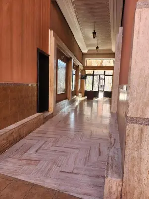 an empty room with a wooden floor and windows at MARRAKECH CENTRE Appartement in Marrakech