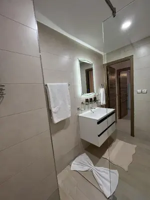 a bathroom with a sink and a glass shower at Marrakech l'aéroport in Marrakech