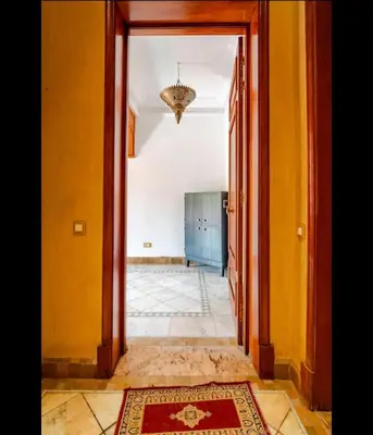 an open doorway to a room with yellow walls at Prestige authentique in Marrakech