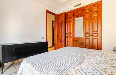 a bedroom with a large bed and wooden cabinets at Prestige authentique in Marrakech