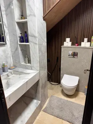 a bathroom with a white toilet and a sink at Duplex Sur Marrakech Guéliz in Marrakech