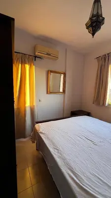 a bedroom with a white bed and two windows at Bright with great view in Marrakech