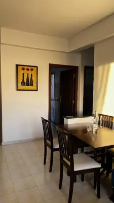 a dining room with a wooden table and chairs at Bright with great view in Marrakech
