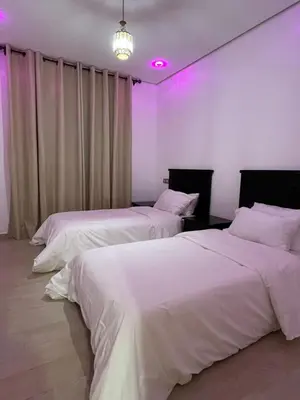 two beds in a room with purple lights at Modern Apartment with Fully Equipped Kitchen Perfect Location in Marrakech in Marrakech