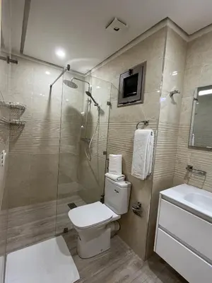 a bathroom with a toilet and a shower and a sink at Modern Apartment with Fully Equipped Kitchen Perfect Location in Marrakech in Marrakech