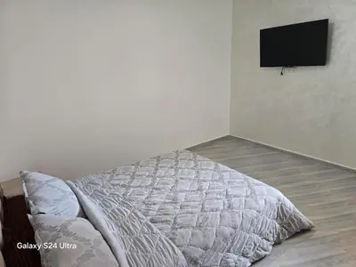 a bedroom with a bed and a flat screen tv at Cozy Apt Near Marrakech Airport in Marrakech