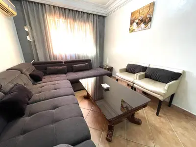 a living room with a couch and a coffee table at Le grand jardin Marrakech in Marrakech