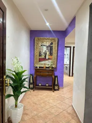 a hallway with a painting on a purple wall at Le grand jardin Marrakech in Marrakech