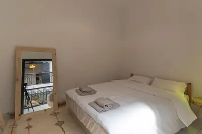 a bedroom with a white bed and a window at HM40 I Moroccan Riad with Residential Pool in Marrakech