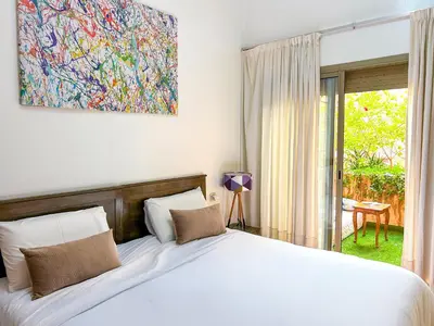 a bedroom with a bed and a painting on the wall at Apartment in City Center - Gueliz in Marrakech